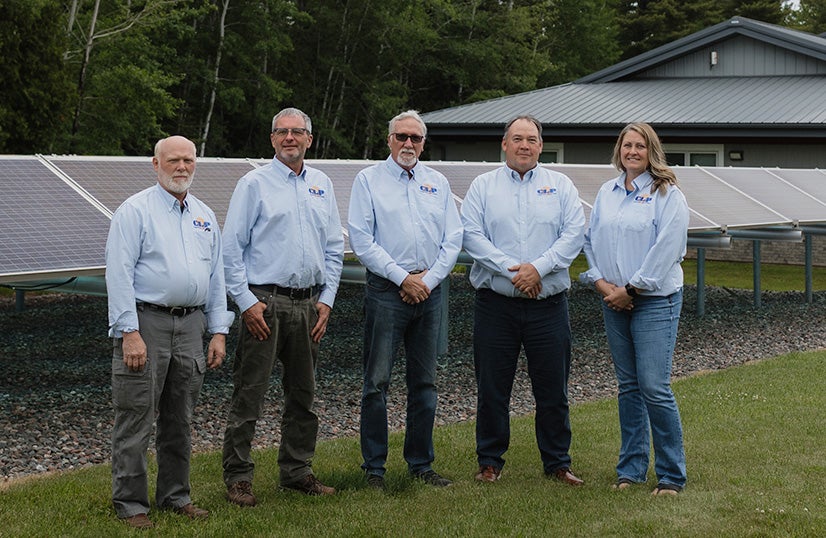 Board standing in front of solar panels